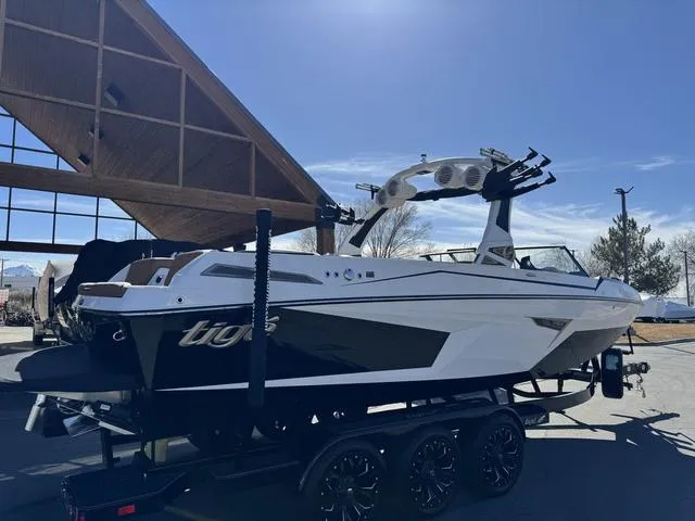 Slide: The Image of 2025 Tigé 24RZX boat on trailer, sleek design, parked outdoors under clear sky. - 6