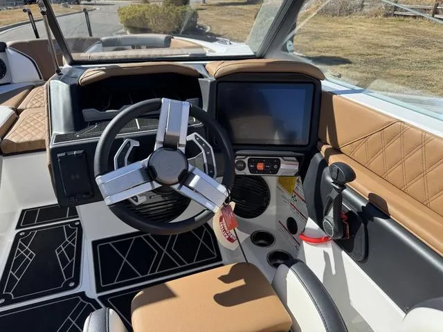 Slide: The Image of 2025 Tigé 24RZX boat interior with steering wheel and touchscreen display. - 8