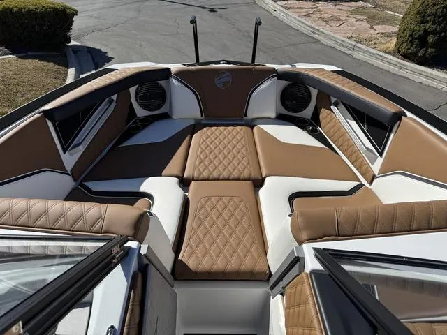 Slide: The Image of 2025 Tigé 24RZX boat interior with brown and white cushioned seating. - 9