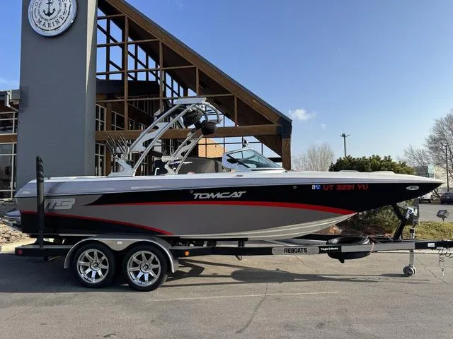 Slide: The Image of 2014 MB SPORTS F24 Tomcat boat on trailer, parked outside a modern building. - 10