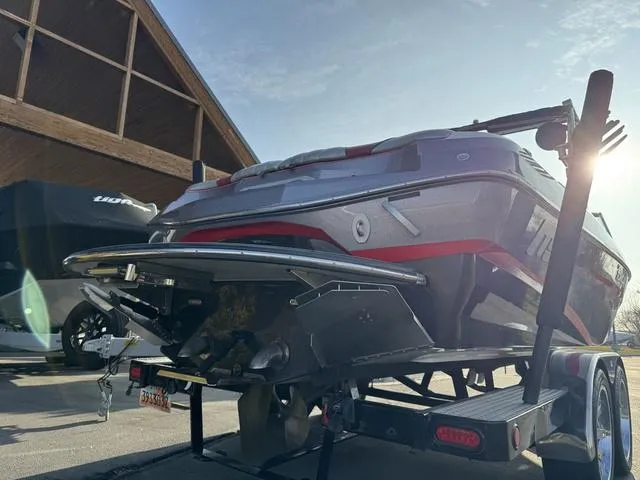 Slide: The Image of 2014 MB SPORTS F24 Tomcat boat on trailer, parked outdoors under sunlight. - 11