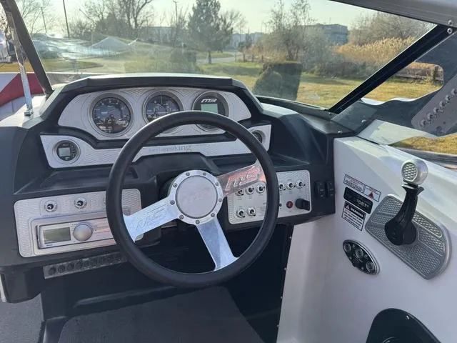 Slide: The Image of 2014 MB SPORTS F24 Tomcat boat dashboard with steering wheel and control panel. - 14