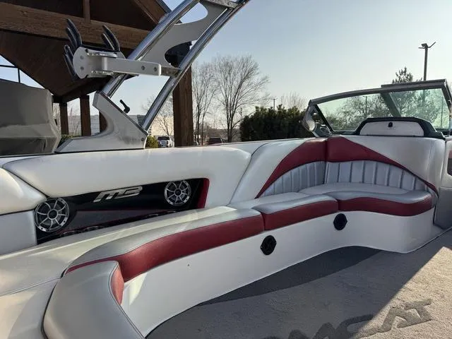 Slide: The Image of 2014 MB SPORTS F24 Tomcat interior with red and white seating, speakers, and sleek design. - 18