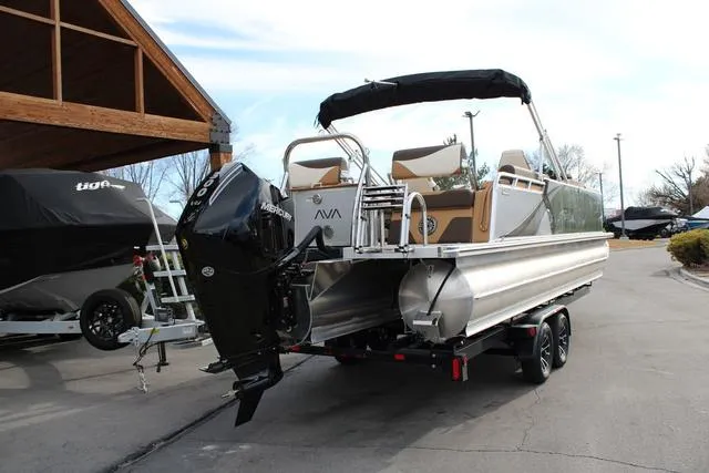 Slide: The Image of 2025 Avalon LSV Quad Lounger Shift pontoon boat with Mercury outboard engine on trailer. - 3