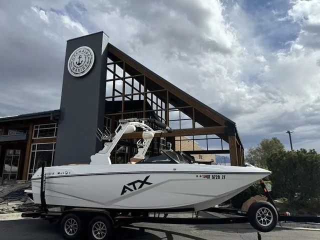 Slide: The Image of 2023 ATX Boats 22 TYPE-S on trailer outside a modern marina building. - 1