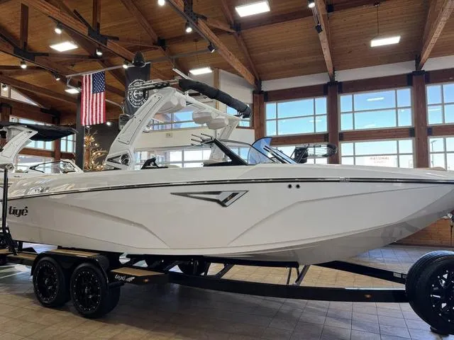 Slide: The Image of 2025 Tigé Z3 boat displayed indoors with wooden ceiling and American flag. - 3