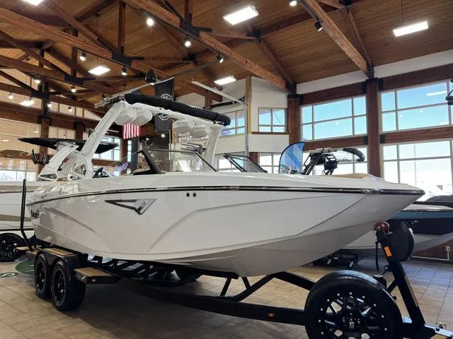 Slide: The Image of 2025 Tigé Z3 boat displayed indoors on a trailer. - 4