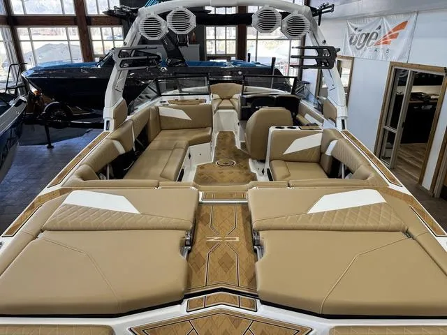 Slide: The Image of 2025 Tigé Z3 boat interior with tan seating and modern design in showroom. - 5