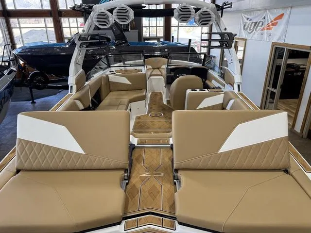 Slide: The Image of 2025 Tigé Z3 boat interior with tan and white seating, wood accents, and modern design. - 9