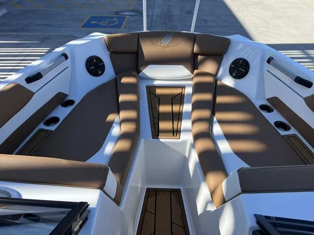 Slide: The Image of 2024 ATX Boats 24 TYPE-S interior with brown and white seating, cup holders, and speakers. - 13