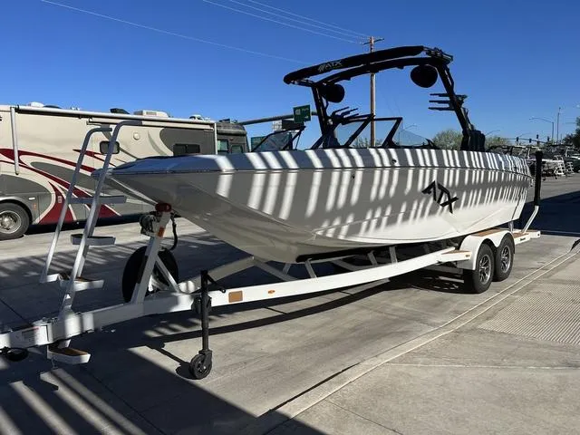 Slide: The Image of 2024 ATX Boats 24 TYPE-S on trailer, parked outdoors under clear blue sky. - 6