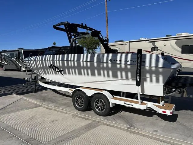 Slide: The Image of 2024 ATX Boats 24 TYPE-S on trailer, parked outdoors under clear blue sky. - 8