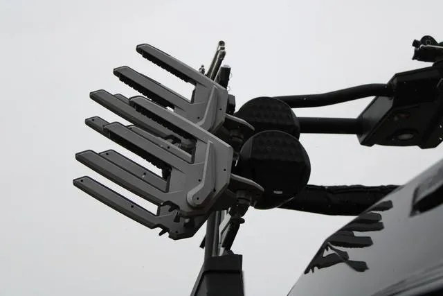 Slide: The Image of Wakeboard rack on 2024 Malibu 26 LSV boat against a cloudy sky. - 10