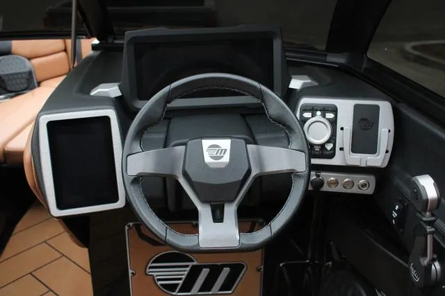 Slide: The Image of 2024 Malibu 26 LSV boat interior with tan leather seating and cup holders. - 7