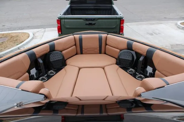 Slide: The Image of Luxurious interior of 2024 Malibu 26 LSV boat with tan leather seating. - 8