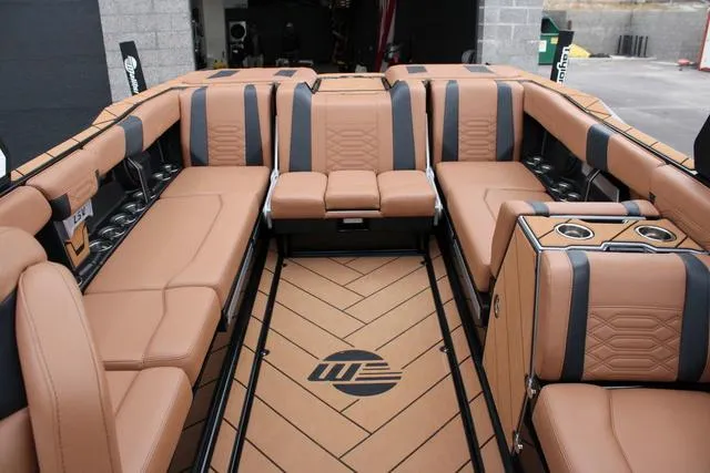 Slide: The Image of Wakeboard rack on 2024 Malibu 26 LSV boat against a cloudy sky. - 9