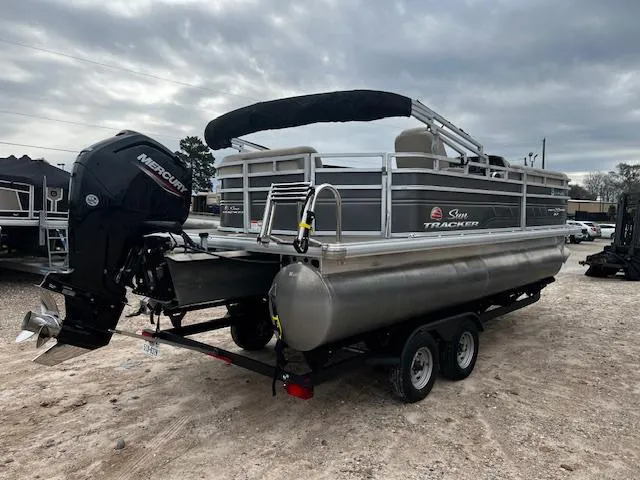 Slide: The Image of 2024 Sun Tracker 20PB pontoon boat with Mercury outboard motor on a trailer. - 3