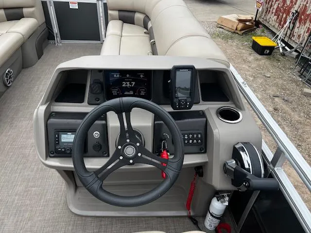 Slide: The Image of 2024 Sun Tracker 20PB boat dashboard with steering wheel, controls, and seating. - 9