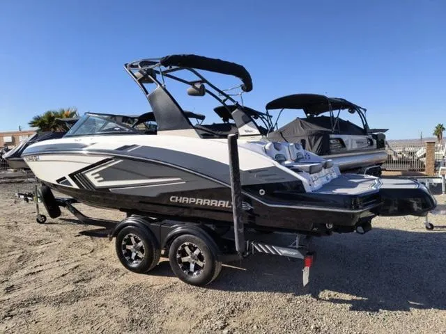 Slide: The Image of 2016 Chaparral Vortex 223 VRX boat on trailer, parked outdoors. - 3