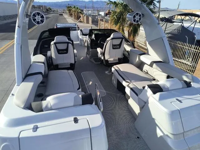 Slide: The Image of Luxurious 2025 Avalon Excalibur Quad Lounge Windshield 27 FT boat with spacious seating and modern design. - 10