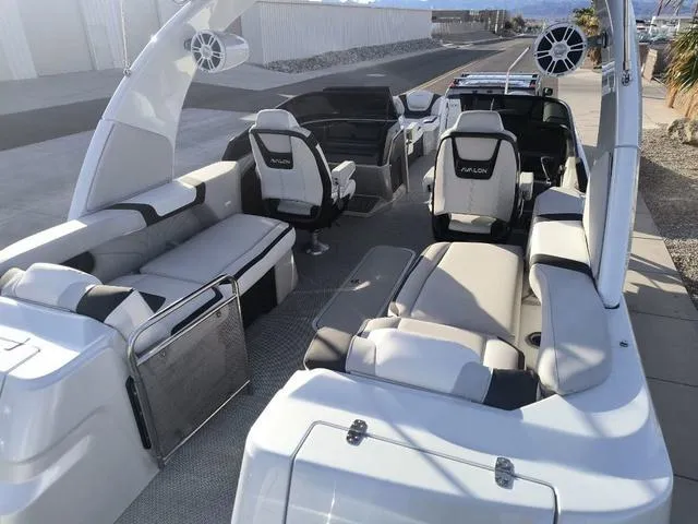 Slide: The Image of 2025 Avalon Excalibur Quad Lounge Windshield 27 FT boat interior with luxurious seating and modern design. - 11