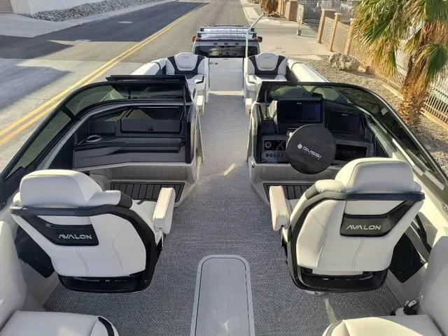 Slide: The Image of 2025 Avalon Excalibur Quad Lounge Windshield 27 FT boat interior with luxurious seating and modern design. - 12