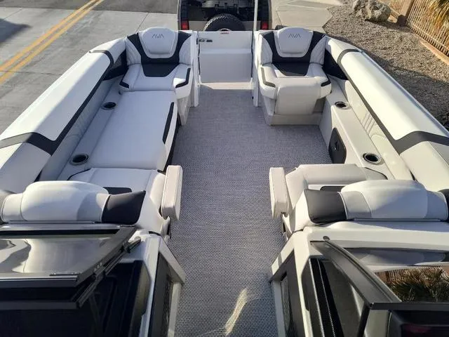 Slide: The Image of 2025 Avalon Excalibur Quad Lounge Windshield 27 FT boat interior with luxurious seating. - 15