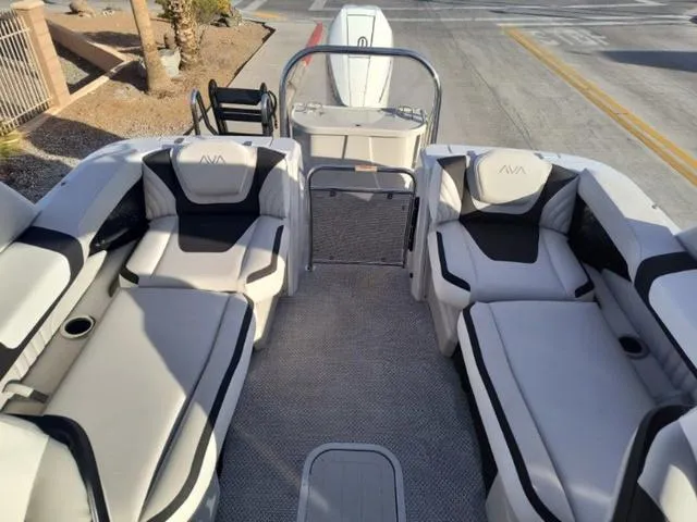Slide: The Image of 2025 Avalon Excalibur Quad Lounge Windshield 27 FT boat interior with plush seating. - 17