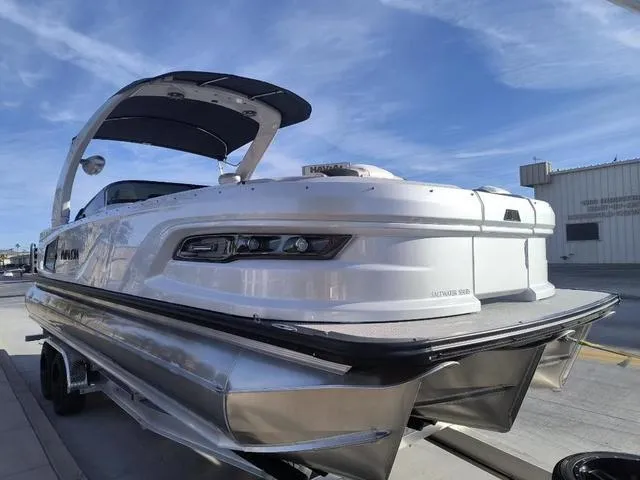 Slide: The Image of 2025 Avalon Excalibur Quad Lounge Windshield 27 FT pontoon boat with sleek design and modern features. - 3