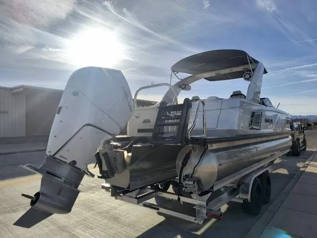 Slide: The Image of 2025 Avalon Excalibur Quad Lounge Windshield 27 FT boat with powerful outboard motor. - 5