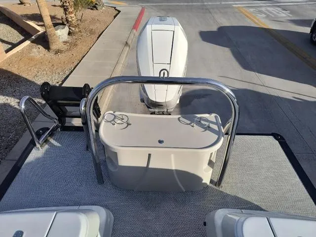 Slide: The Image of 2025 Avalon Excalibur Quad Lounge Windshield 27 FT boat, rear view with outboard motor. - 9