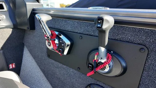 Slide: The Image of 2025 Lund 2075 Fisherman Sport boat controls with red safety lanyards. - 10