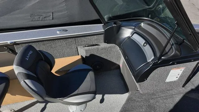 Slide: The Image of 2025 Lund 2075 Fisherman Sport boat interior with seating and dashboard. - 11