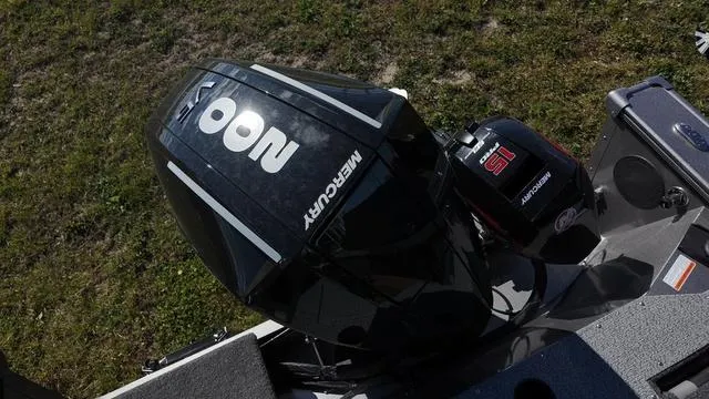 Slide: The Image of 2025 Lund 2075 Fisherman Sport with Mercury outboard engine, parked on grass. - 18