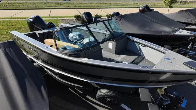 Slide: The Image of 2025 Lund 2075 Fisherman Sport boat on trailer, parked outdoors. - 2