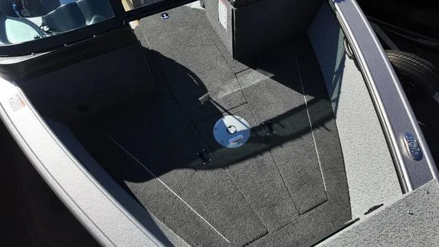 Slide: The Image of 2025 Lund 2075 Fisherman Sport boat interior with carpeted flooring and storage compartments. - 3