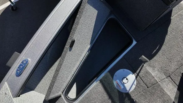 Slide: The Image of 2025 Lund 2075 Fisherman Sport boat interior with open storage compartment. - 5