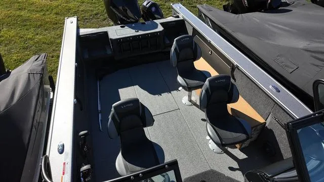 Slide: The Image of 2025 Lund 2075 Fisherman Sport boat interior with four seats, gray flooring, and spacious layout. - 7