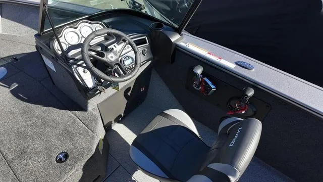 Slide: The Image of Interior of 2025 Lund 2075 Fisherman Sport boat with steering wheel and seating. - 8