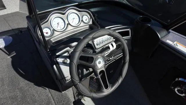 Slide: The Image of 2025 Lund 2075 Fisherman Sport dashboard with steering wheel and gauges. - 9