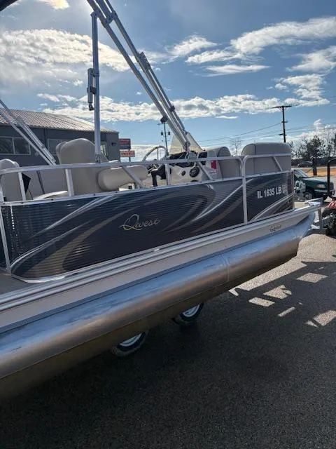 Slide: The Image of 2021 Quest le816 pontoon boat with sleek design, parked outdoors under a sunny sky. - 4