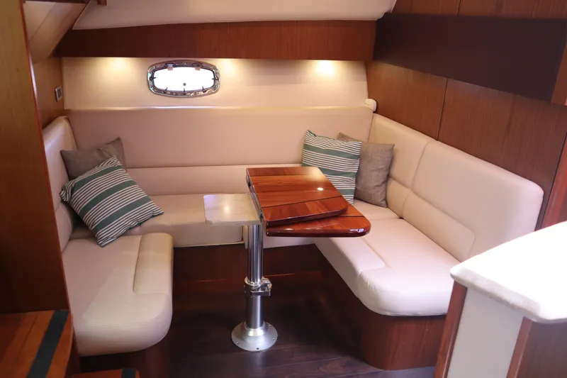 Slide: The Image of 2016 Tiara Yachts 4300 Open interior with cozy seating and wooden table. - 10