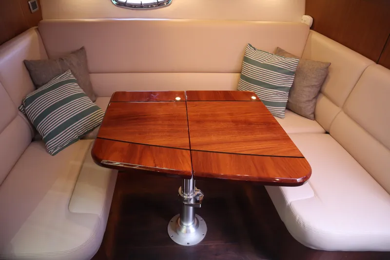 Slide: The Image of Luxurious interior of 2016 Tiara Yachts 4300 Open with elegant wood table and plush seating. - 12