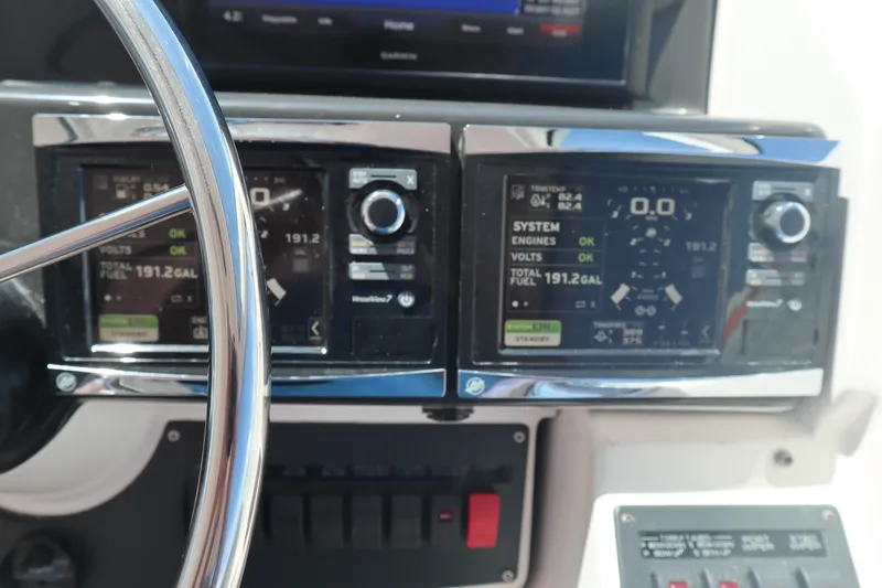 Slide: The Image of Dashboard of a 2016 Tiara Yachts 4300 Open, featuring navigation and control displays. - 14