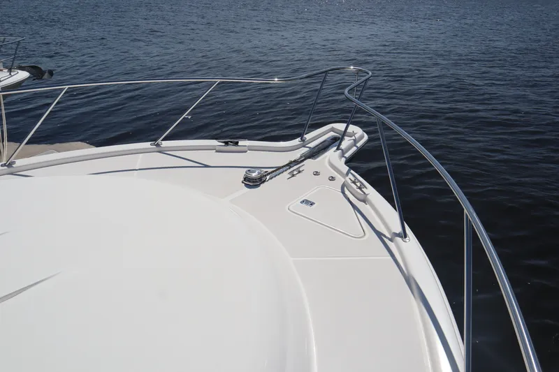 Slide: The Image of 2016 Tiara Yachts 4300 Open bow with stainless steel railings on calm water. - 16