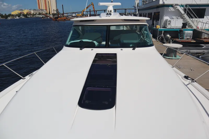 Slide: The Image of 2016 Tiara Yachts 4300 Open docked, showcasing sleek design and spacious deck. - 19