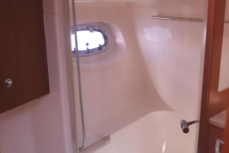Slide: The Image of Bathroom interior of 2016 Tiara Yachts 4300 Open, featuring a shower and porthole window. - 21