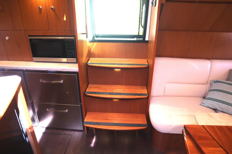 Slide: The Image of Interior of 2016 Tiara Yachts 4300 Open with wooden steps and modern kitchen amenities. - 22