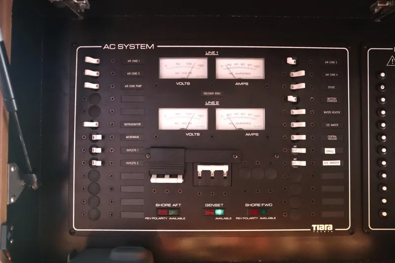 Slide: The Image of AC system panel on 2016 Tiara Yachts 4300 Open, displaying voltage and amperage meters. - 23