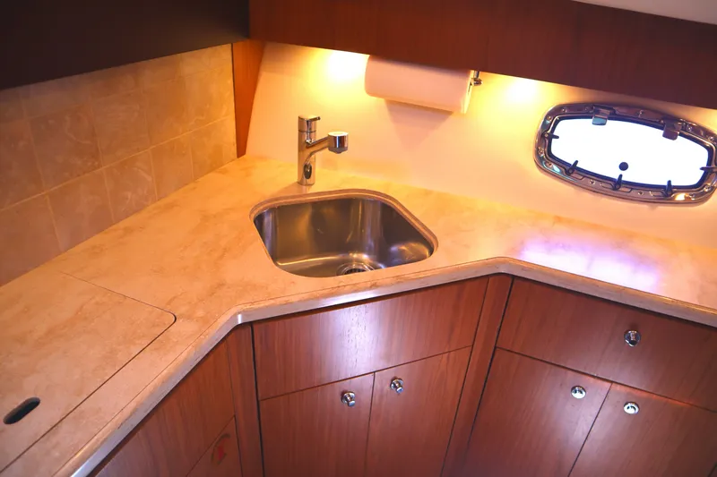 Slide: The Image of Luxurious 2016 Tiara Yachts 4300 Open kitchen with sink and wooden cabinetry. - 25
